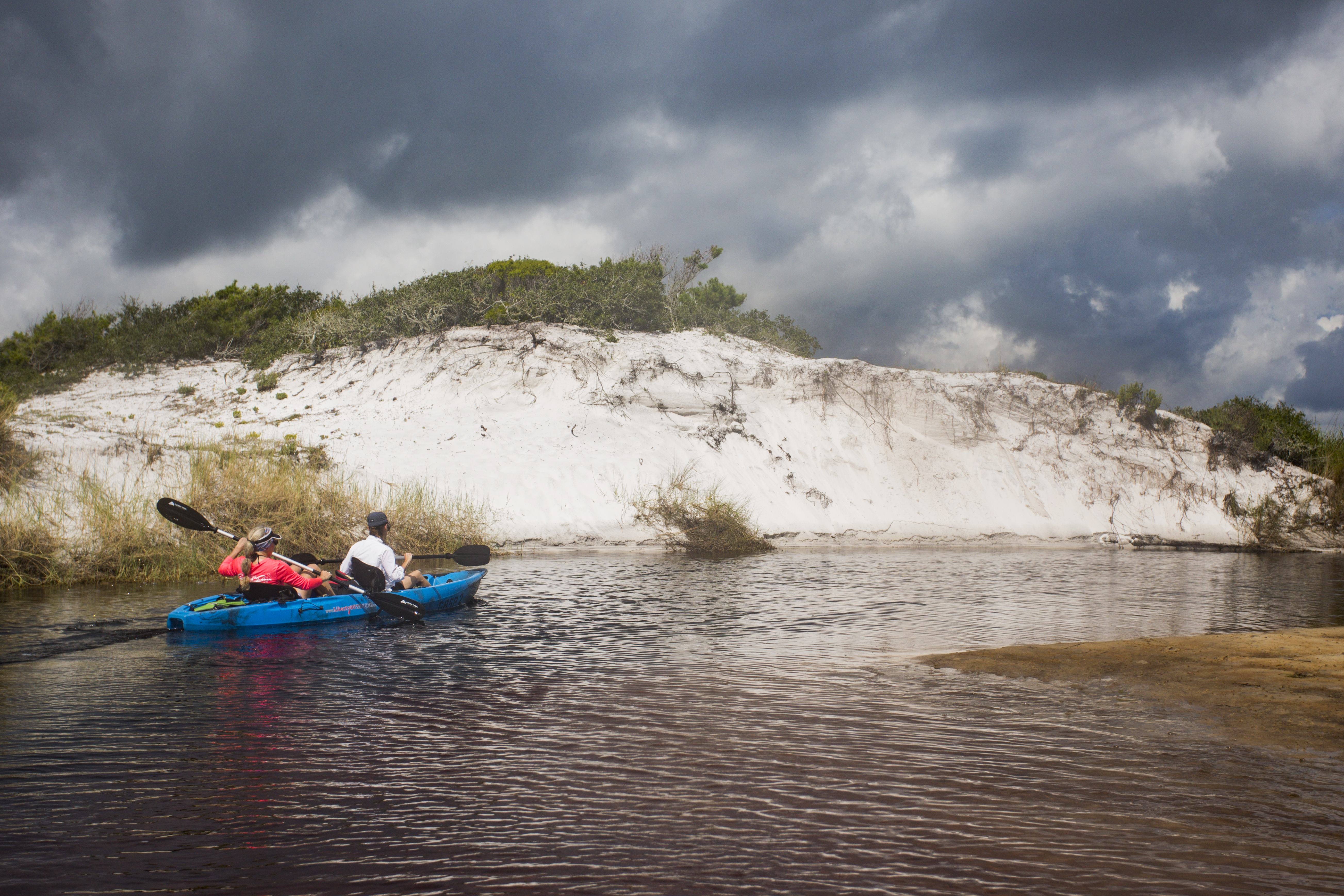 People kayaking at a natural dune lake near Sandestin, Florida. Photo taken 09-26-18.