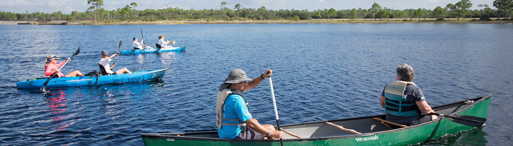 People kayaking and canoeing on a Florida lake.