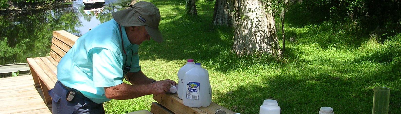 Photo of a volunteer testing a sample of water
